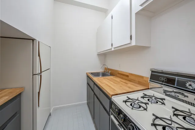 a bedroom with a bed and a night stand