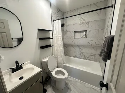 a bathroom with a sink toilet and shower