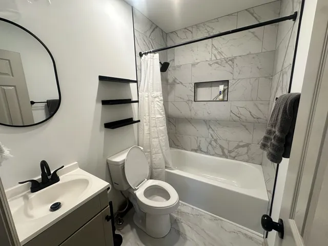 a bathroom with a sink toilet and shower