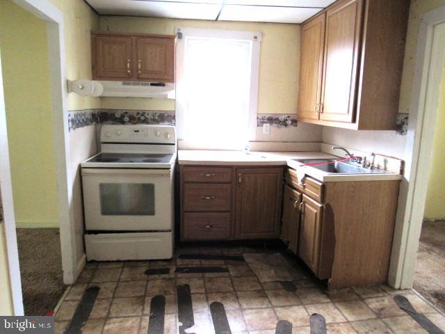 172 Boston Road Pennsville, NJ 08070 - Photo 5 of 9 a kitchen with a stove sink and cabinets
