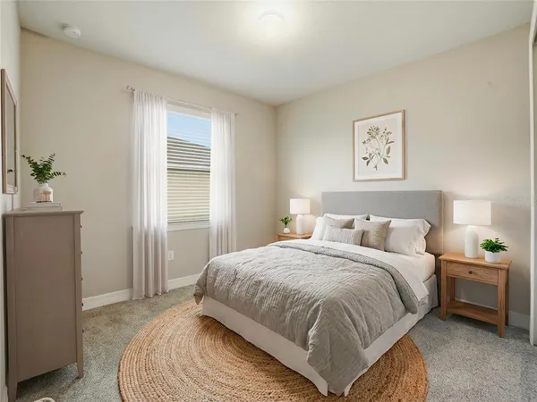 a bedroom with a large bed and a window