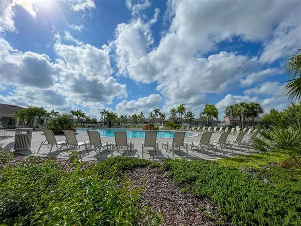 a view of a lake with a table and chairs
