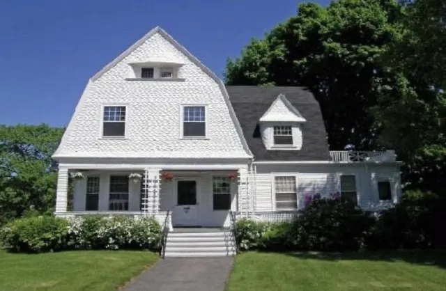 a front view of a house with garden