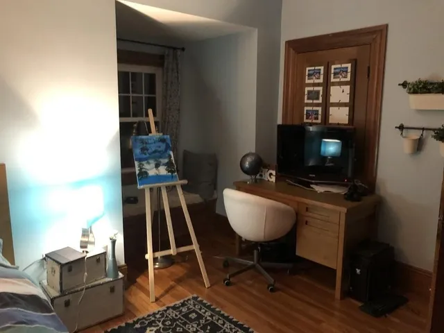 a living room with furniture a flat screen tv and a table