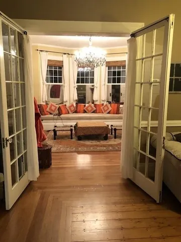 a view of a living room with furniture and wooden floor