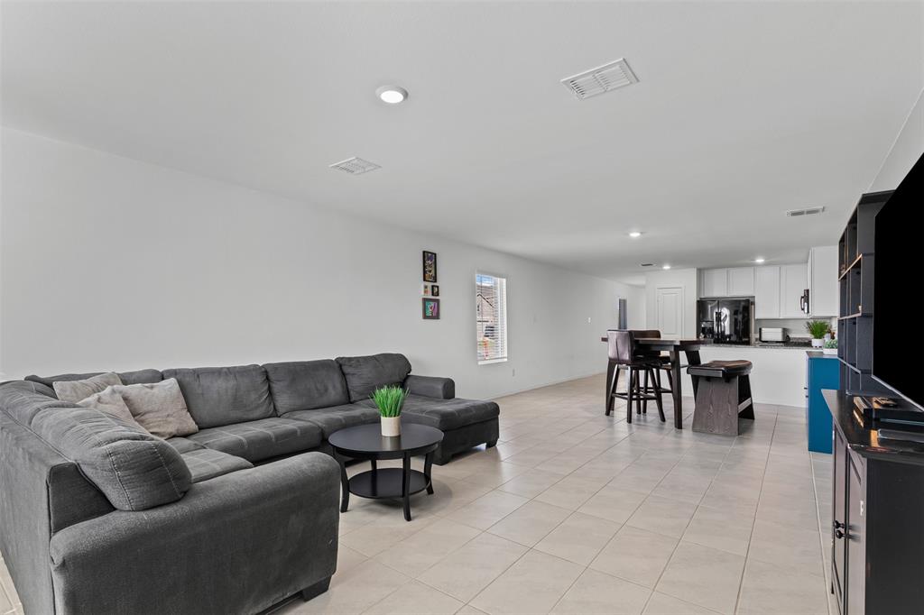 Living area featuring light tile patterned flooring and recessed lighting