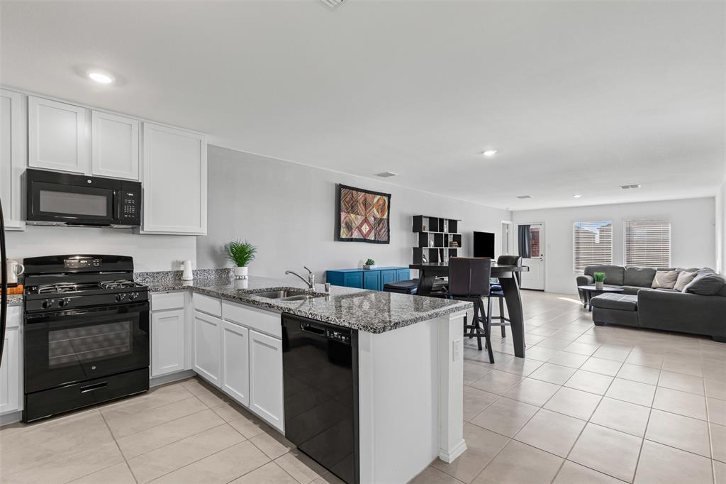 14004 Gaskin Street Pilot Point, TX 76258 - Photo 31 of 31 a kitchen with counter top space appliances and cabinets
