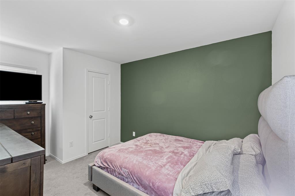 14004 Gaskin Street Pilot Point, TX 76258 - Photo 12 of 31 a bedroom with a bed and a flat screen tv