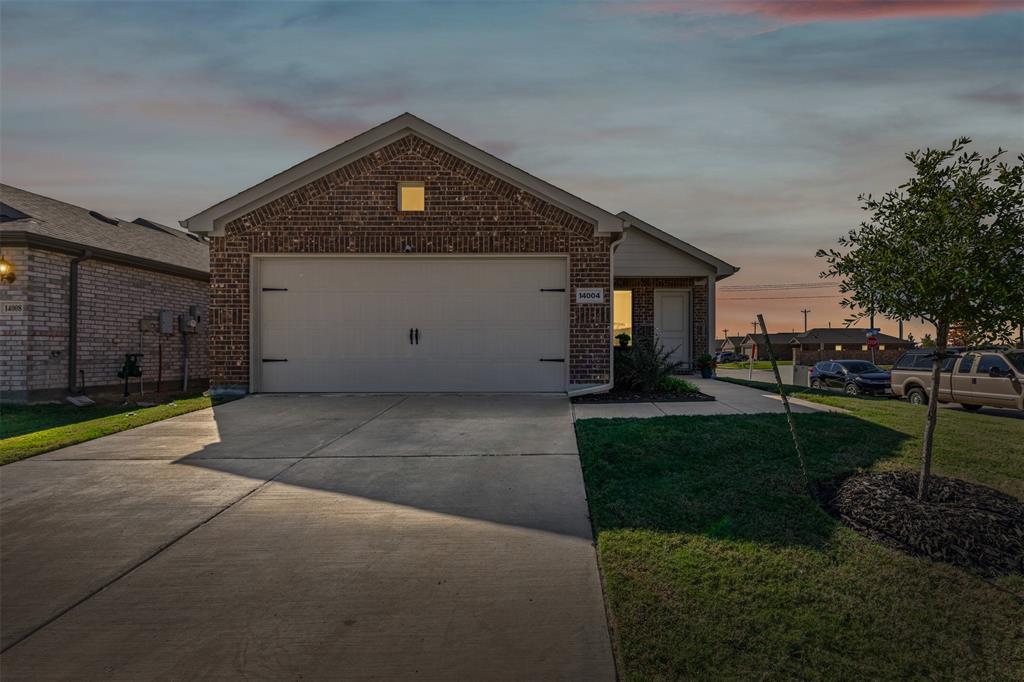 14004 Gaskin Street Pilot Point, TX 76258 - Photo 2 of 31 a front view of a house with garden
