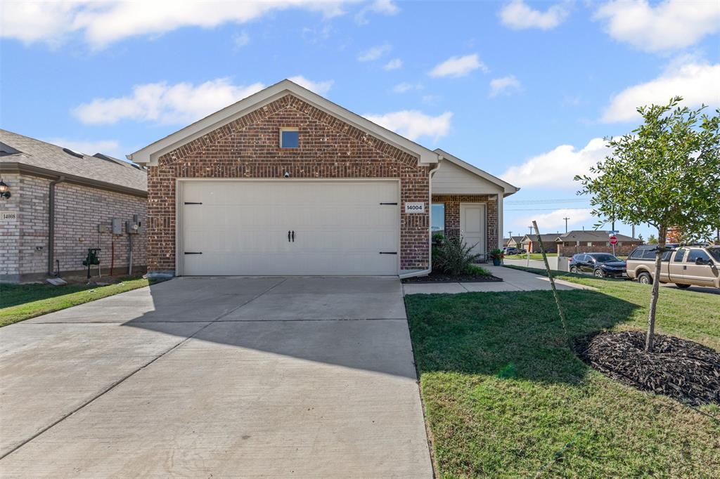 14004 Gaskin Street Pilot Point, TX 76258 - Photo 4 of 31 a front view of a house with a yard and garage