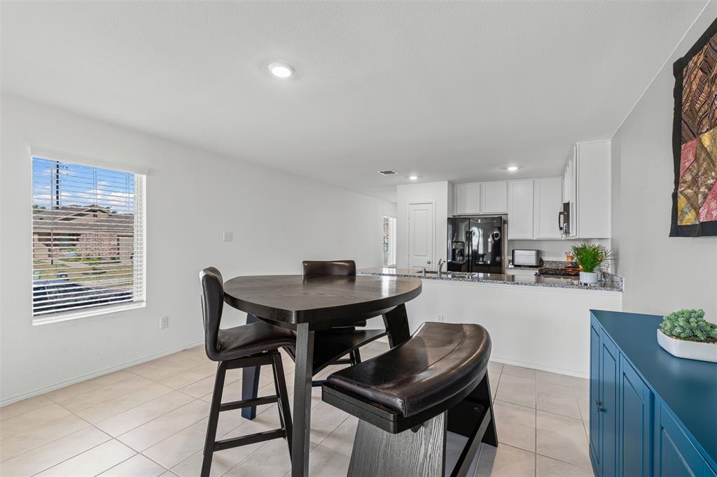 14004 Gaskin Street Pilot Point, TX 76258 - Photo 6 of 31 a view of a dining room with furniture and a potted plant