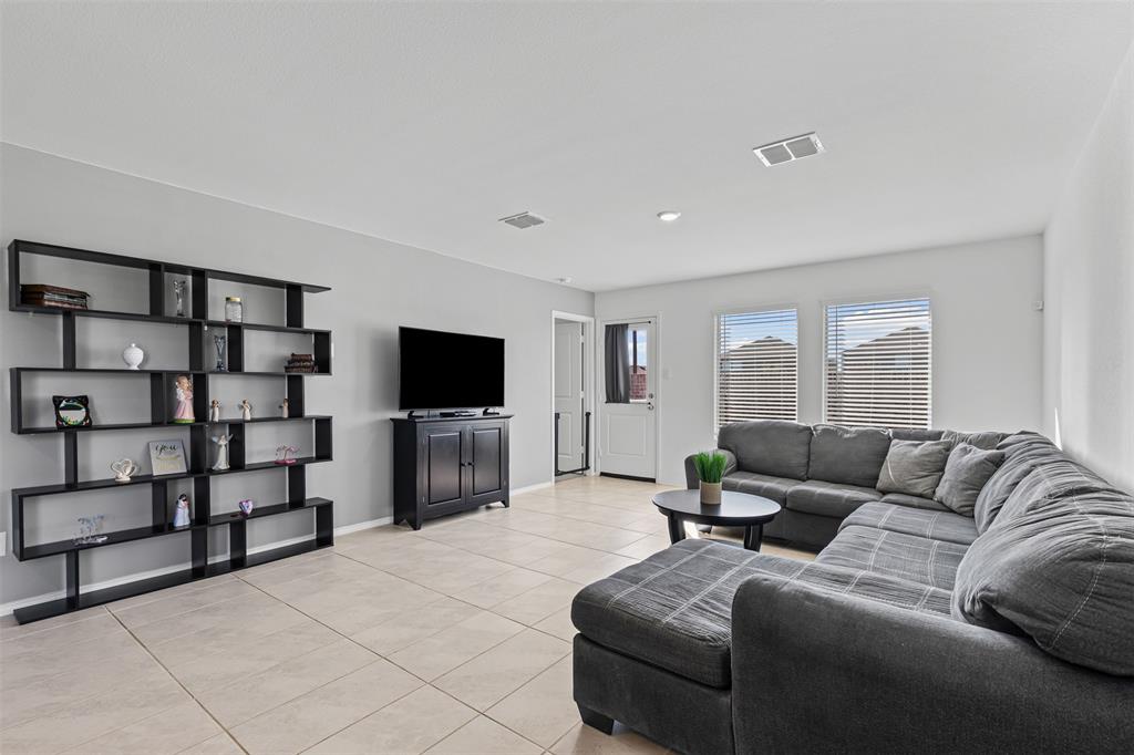 14004 Gaskin Street Pilot Point, TX 76258 - Photo 8 of 31 a living room with furniture and a flat screen tv