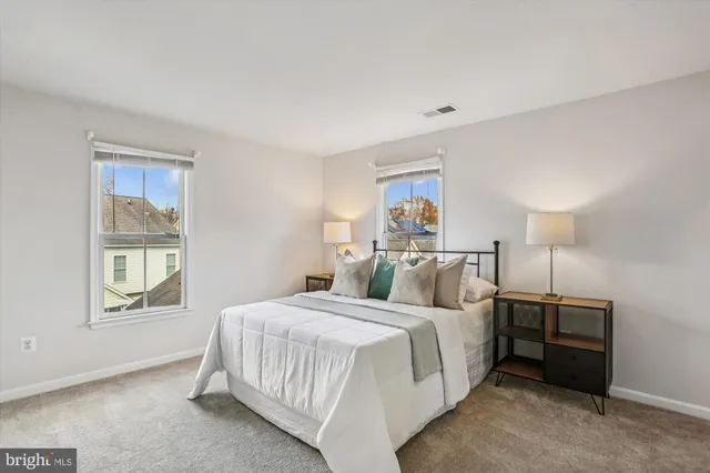 a bedroom with a bed and a night stand