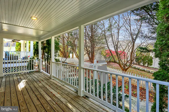 a view of a porch with wooden floor and fence