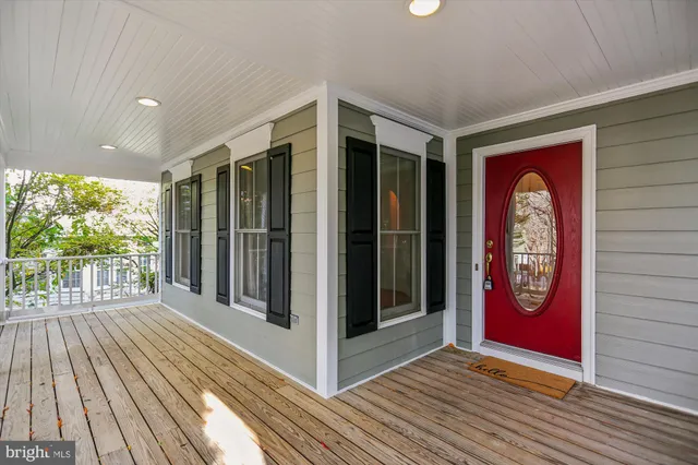 a view of a hallway with wooden floor and a fireplace
