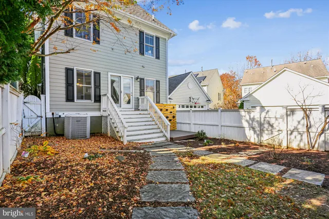a view of a house with a yard and potted plants