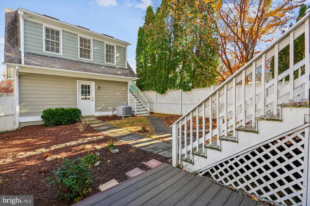 a view of an empty room with closet and a window