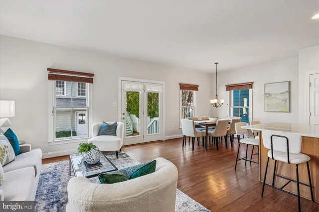 a living room with furniture wooden floor and a window