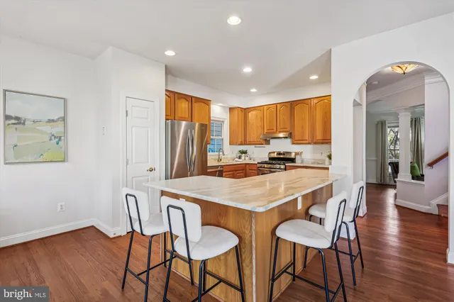 a kitchen with a table chairs refrigerator and cabinets