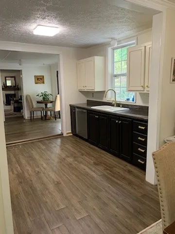 a spacious bathroom with a granite countertop sink and a mirror