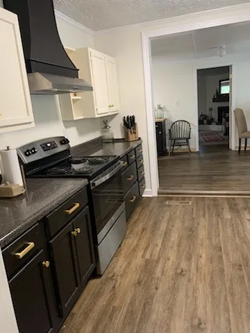 a kitchen with wooden cabinets and a stove top oven