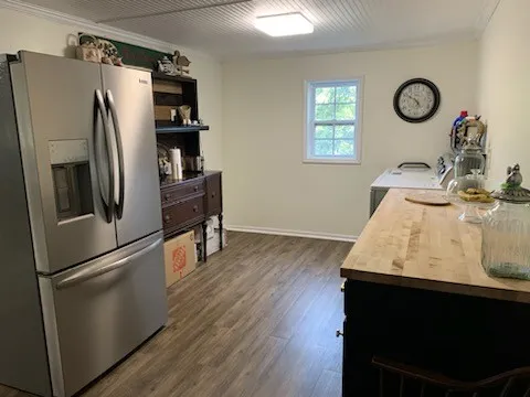 a kitchen with stainless steel appliances a refrigerator and a stove top oven