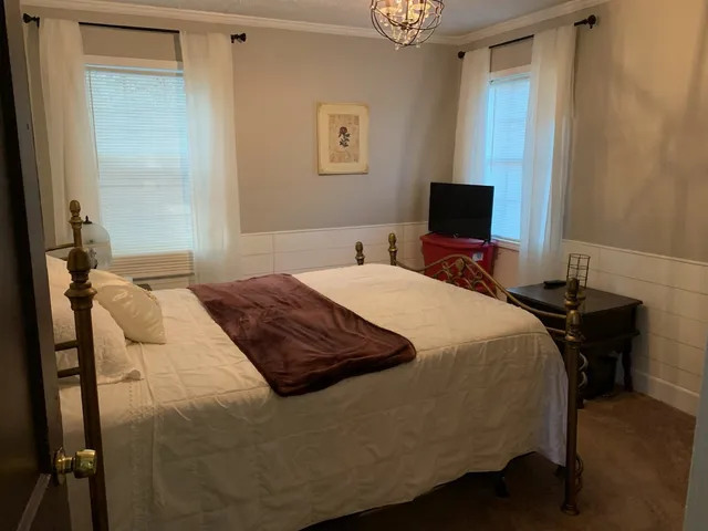 a bedroom with a bed and a flat screen tv