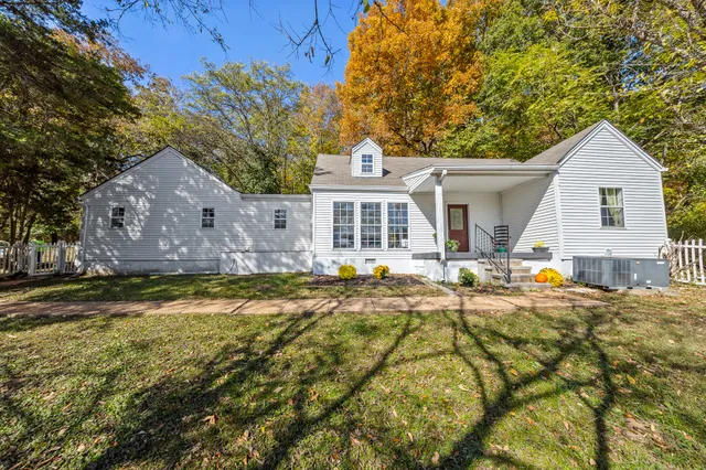 a view of a house with pool and sitting area