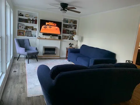 a living room with furniture a fireplace and a flat screen tv