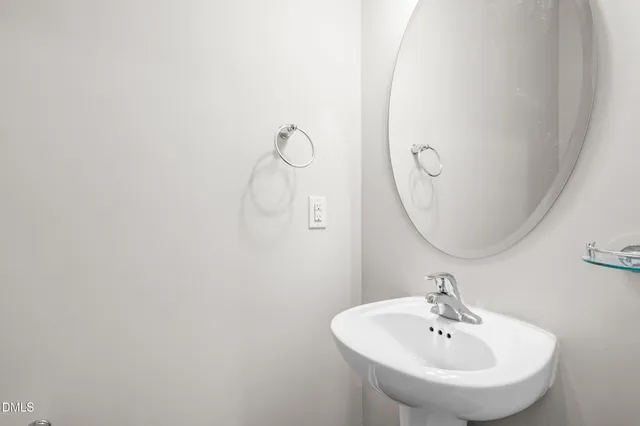 a bathroom with a sink and mirror
