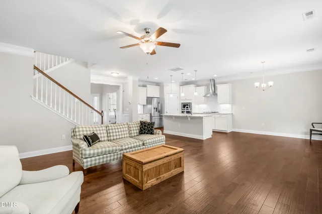 a living room with furniture and a view of kitchen