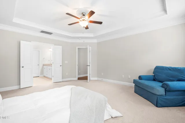 a spacious bedroom with a bed and a couch