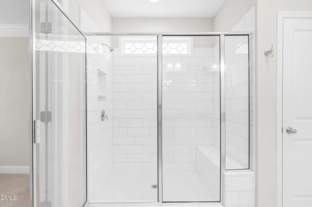 a bathroom with a glass shower door