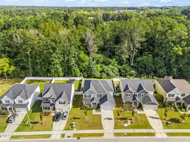 a view of yard with swimming pool and seating space