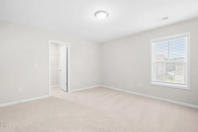 an empty room with a empty space and a window