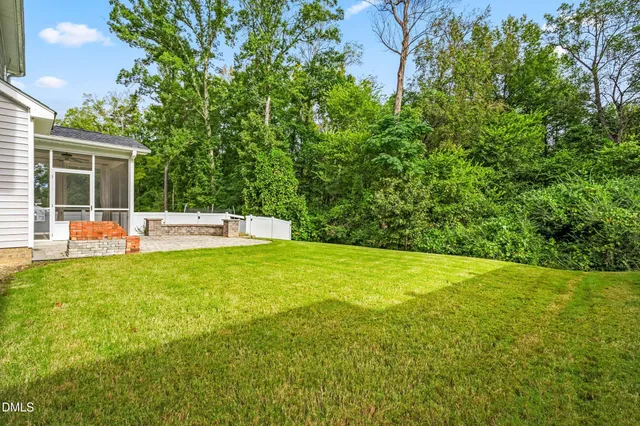 a backyard of a house with yard and outdoor seating