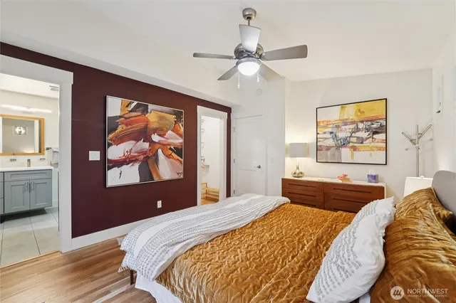 a bedroom with a large bed and a chandelier