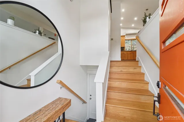 a view of entryway and hall with wooden floor
