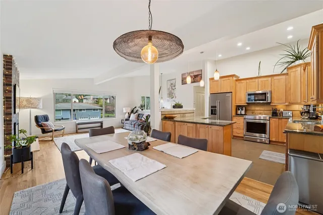 a view of a dining room with furniture kitchen and chandelier