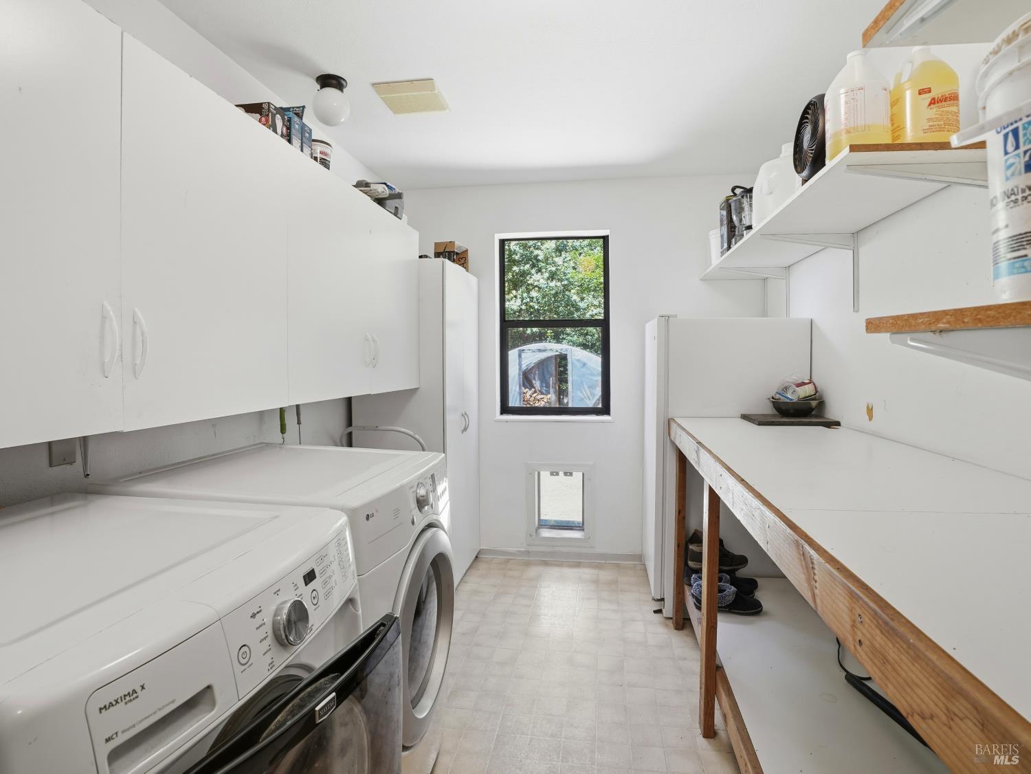 31397 Seaview Road Cazadero, CA 95421 - Photo 27 of 47 a utility room with cabinets washer and dryer