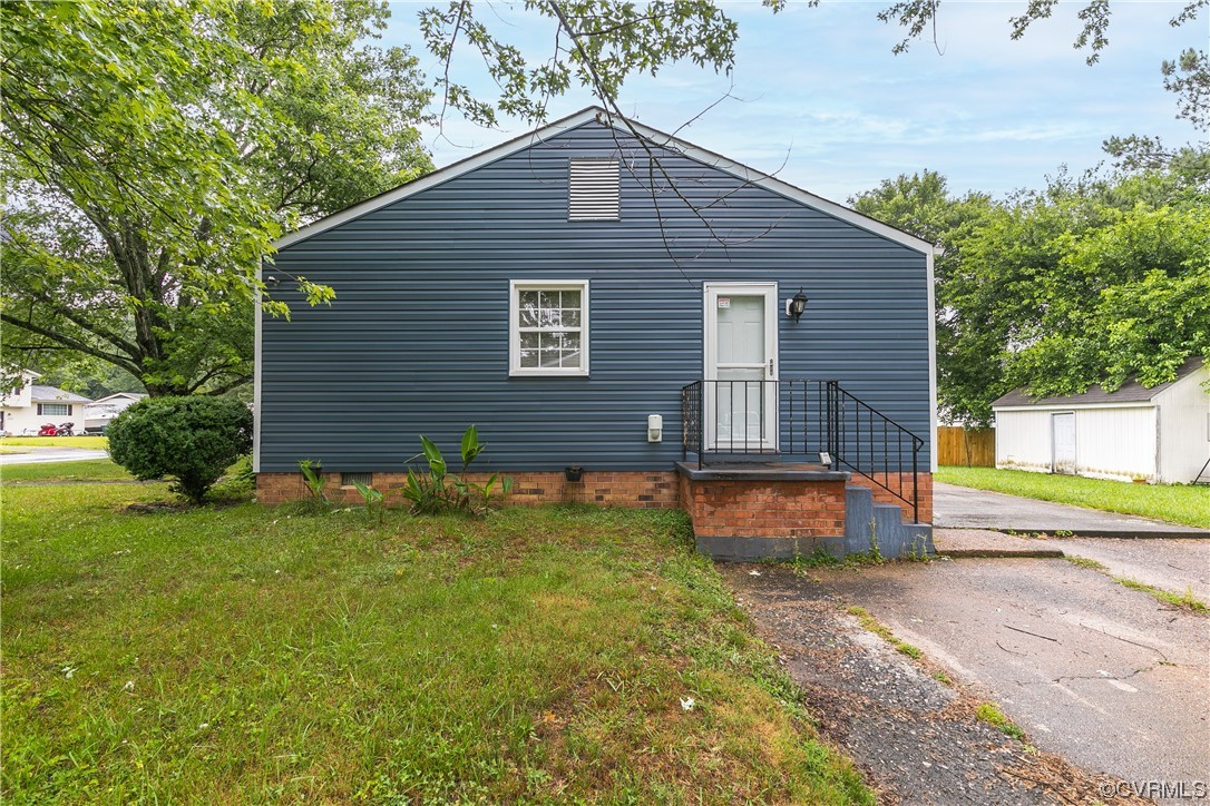 227 Hodder Lane Henrico, VA 23075 - Photo 4 of 24 a brick house with a yard plants and big yard