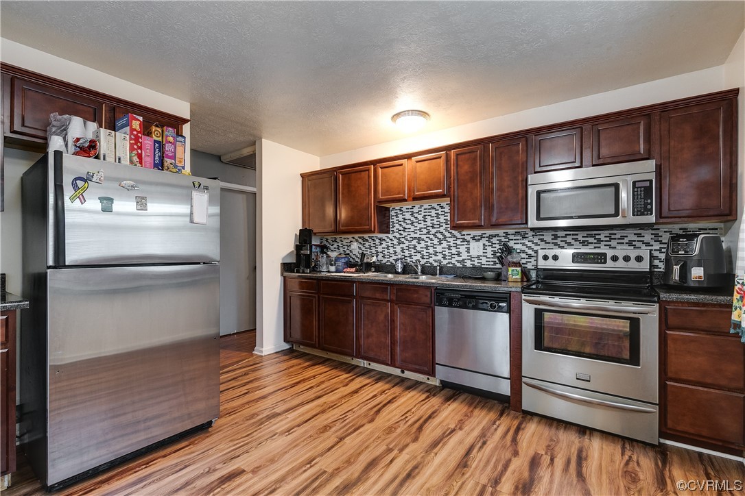 227 Hodder Lane Henrico, VA 23075 - Photo 8 of 24 a kitchen with stainless steel appliances kitchen island granite countertop a refrigerator stove and oven