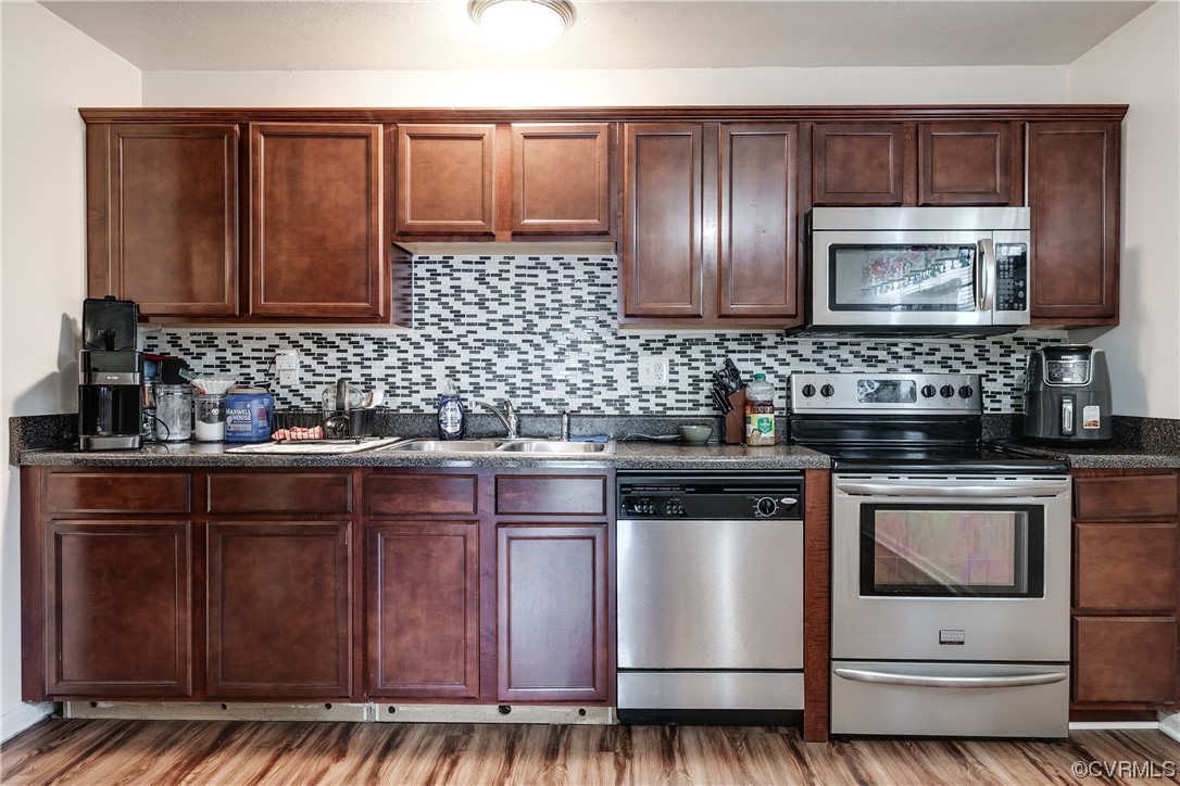 227 Hodder Lane Henrico, VA 23075 - Photo 10 of 24 a kitchen with stainless steel appliances granite countertop wooden cabinets and a stove top oven