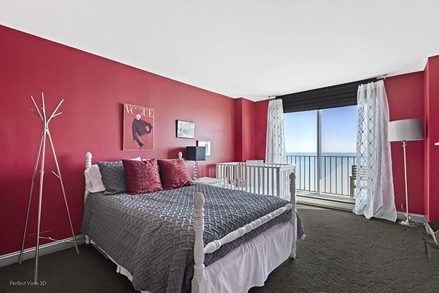 6033 North Sheridan Road, Unit 16A Chicago, IL 60660 - Photo 15 of 21 a bedroom with a bed and a lamp with wooden floor