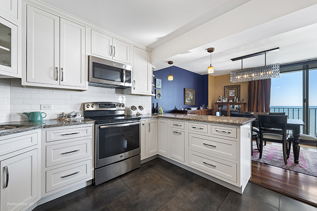6033 North Sheridan Road, Unit 16A Chicago, IL 60660 - Photo 5 of 21 a kitchen with stainless steel appliances white cabinets and a sink