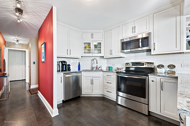 6033 North Sheridan Road, Unit 16A Chicago, IL 60660 - Photo 6 of 21 a kitchen with stainless steel appliances granite countertop a stove a sink and a microwave