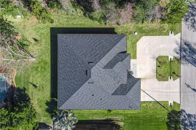 an aerial view of a house with a yard