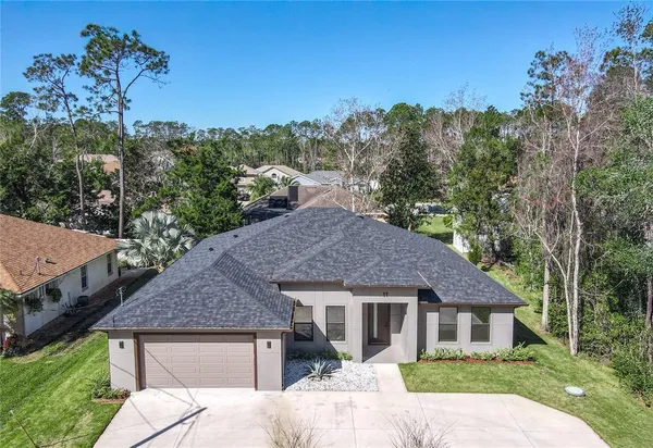 a aerial view of a house with a yard