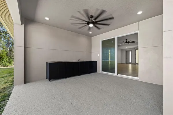 a large kitchen with a sink a counter top space appliances and cabinets