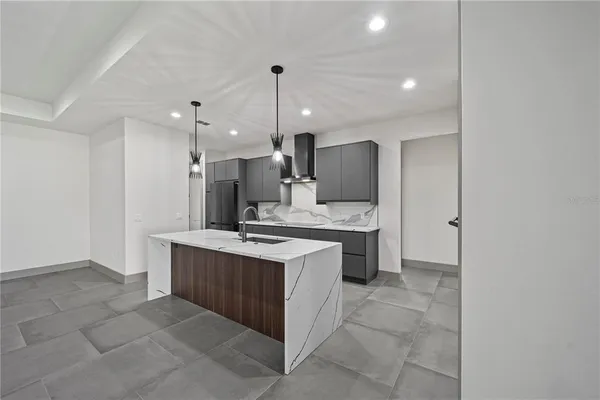 a view of a room with a sink and chandelier